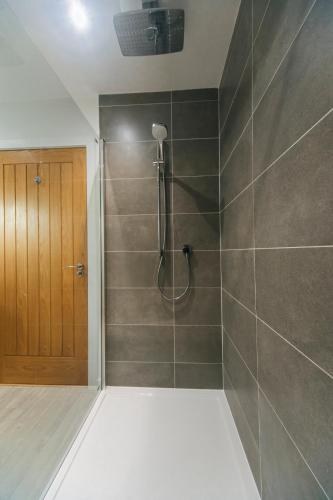 a bathroom with a shower with a wooden door at The Star House in Glendale