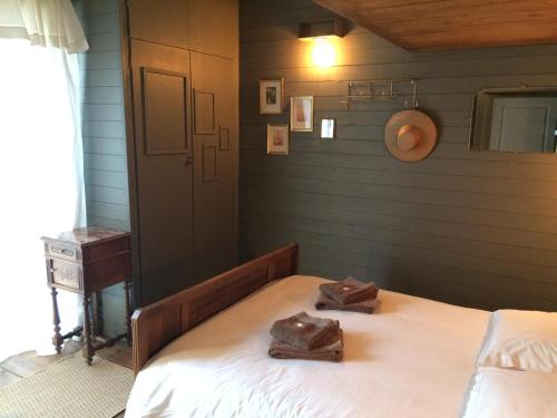 a bedroom with a bed with two shoes on it at Bistrot Vintage "Chez Mamie Léone" in Lèzan