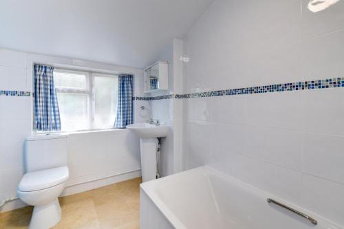 a white bathroom with a toilet and a sink at 3 Bed in Bridport oc-wy401 in Bridport