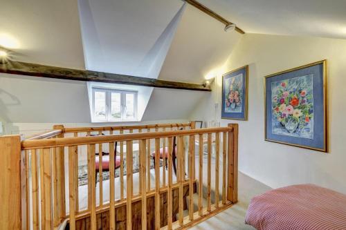a room with a wooden staircase with paintings on the wall at 3 Bed in Bridport oc-wy401 in Bridport