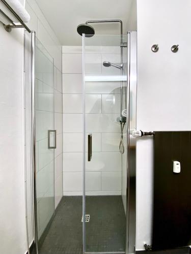 a shower with a glass door in a bathroom at Hotel Credé in Kassel