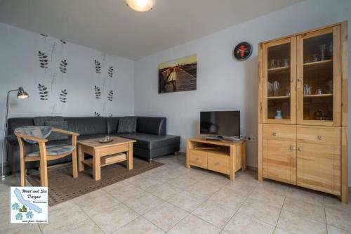a living room with a couch and a table at Wald und See Dargun 16b in Dargun