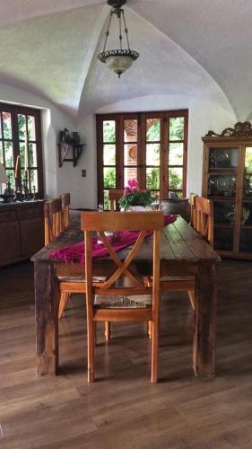 a dining room with a wooden table and a dining room at Hotel Casa del Angel in Tepoztlán