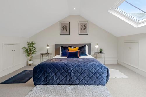 a bedroom with a large blue bed in a attic at Osbourne House - BLUE 2 Bedroom,2 and half bath in Birmingham