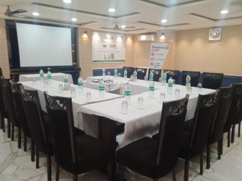 a conference room with a long table with chairs at Hotel Rahul Deluxe in Nagpur