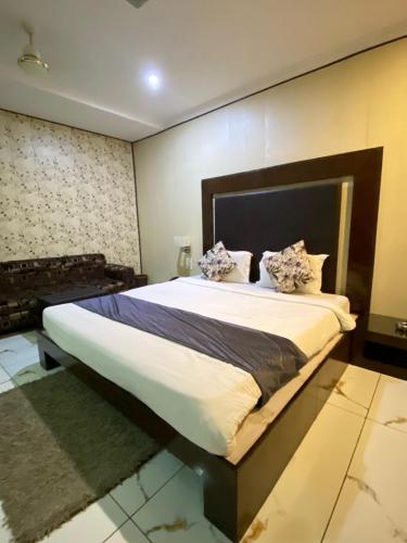 a bedroom with a large bed in a room at Hotel Rahul Deluxe in Nagpur