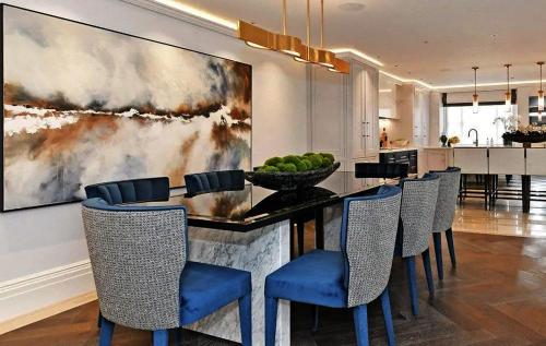 a dining room with a table with chairs and a painting at Kos blue & green in Kos