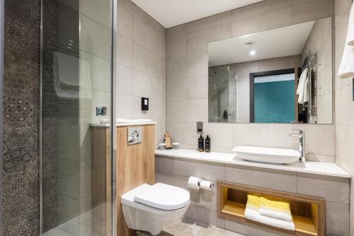 a bathroom with a toilet and a sink and a shower at Mercure Newcastle George Washington Hotel Golf & Spa in Newcastle upon Tyne