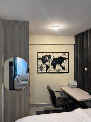 a bedroom with a desk and a chair and a mirror at Sitati in Ruaka