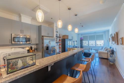 a kitchen with a counter with a fish tank at King Master and Plush Queen near NYC w kitchen, living room plus on-site gym in Jersey City