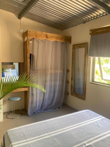 a bedroom with a bed and a window at The Voyager Océan View in Port Mathurin