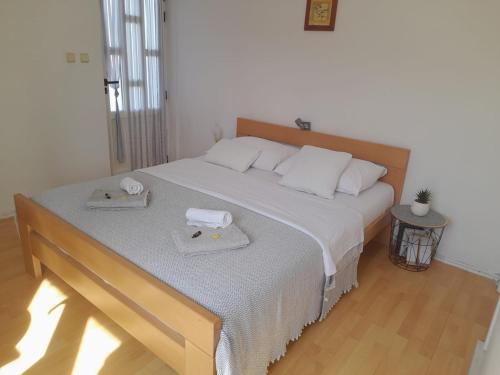 a bedroom with a large bed with two towels on it at Studio apartment in town center in Stari Grad