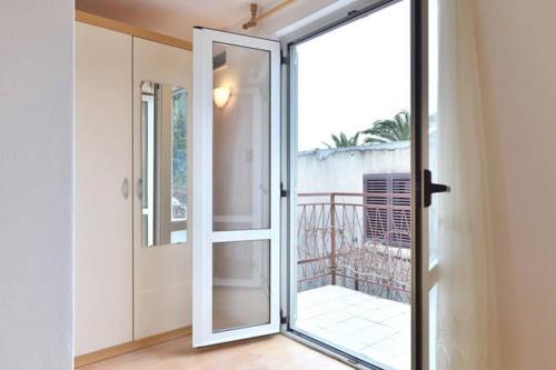 a sliding glass door in a room with a balcony at Studio apartment in town center in Stari Grad