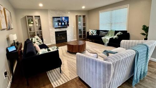 a living room with two couches and a fireplace at Beautiful home next train station close to boston in Holbrook