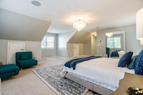a bedroom with a bed and a blue chair at Beautiful home next train station close to boston in Holbrook