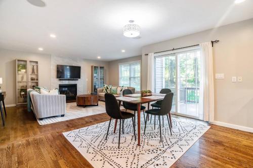 a dining room and living room with a table and chairs at Beautiful home next train station close to boston in Holbrook