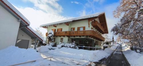 a building covered in snow with snow around it at Ferienwohnung Liebau in Bayerisch Eisenstein
