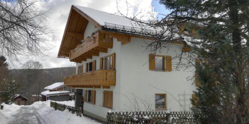 a house with wooden balconies on the side of it at Ferienwohnung Liebau in Bayerisch Eisenstein