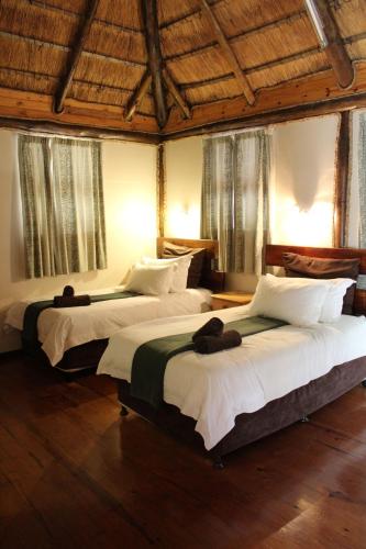 a bedroom with two beds with hats on them at Sodwana Bay Lodge Dive & Fishing Resort in Sodwana Bay