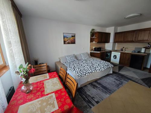 a small room with a bed and a kitchen at Bansko Pirin Golf & Country Club Blue Mountains View in Razlog
