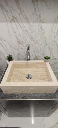 a wooden sink with a faucet in a bathroom at A casa di Ro 2 in Nola