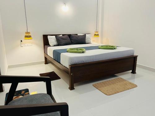 a bedroom with a bed with two green pillows on it at Luxury Living Villas in Matara