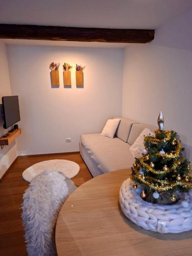 a living room with a christmas tree on a table at La Casa di Lumi in Lanzada