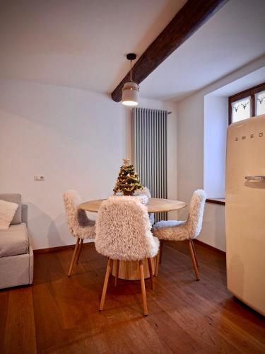 a living room with a table with a christmas tree on it at La Casa di Lumi in Lanzada