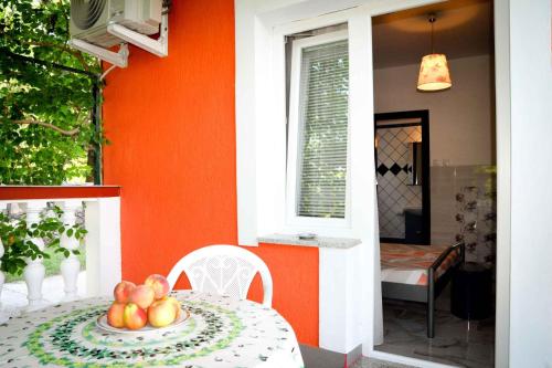 a table with a bowl of fruit on top of it at Apartments in Lopar - Insel Rab 36282 in Lopar