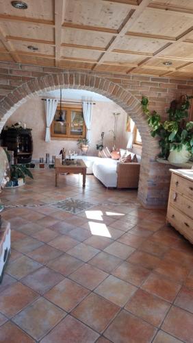 a living room with an archway with a couch and a table at Ferienhaus Kleinlercher in Iselsberg