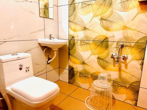 a bathroom with a toilet and a sink at hello 6 cliff stay varkalacliff - cozy rooms , couple friendly ,family ,group rooms in Varkala
