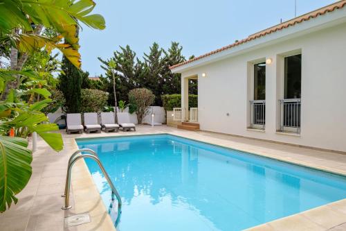 a swimming pool in the backyard of a house at Villa with private pool in Pervolia, Larnaca in Perivolia