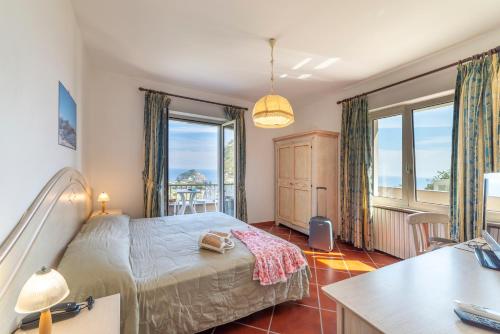 a bedroom with a bed and a large window at Punta Chiarito Resort in Forio d'Ischia