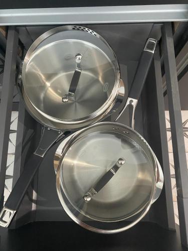 two metal pans sitting on top of a shelf at The Woodquay House in Galway