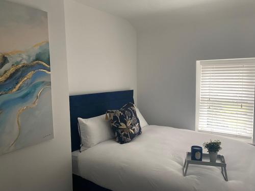 a bedroom with a bed with a painting on the wall at The Woodquay House in Galway