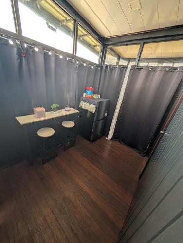 a bathroom with a table and two stools in it at The G Residence in Calatagan