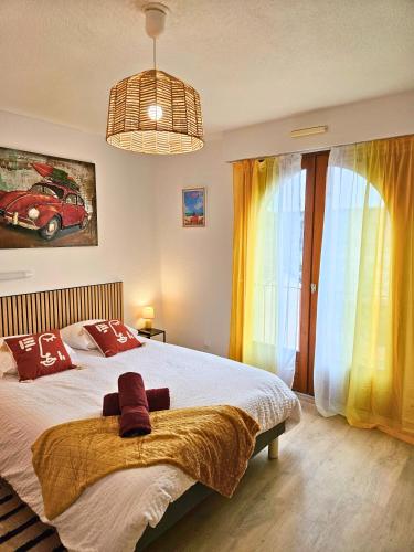 a bedroom with a bed and a large window at ''Coccinelle'' WIFI - CENTRE - MODERNE in Dax