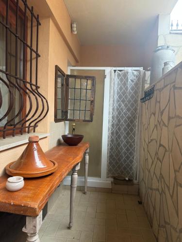 a bathroom with a wooden table with a sink and a shower at Liguorini House in Avellino