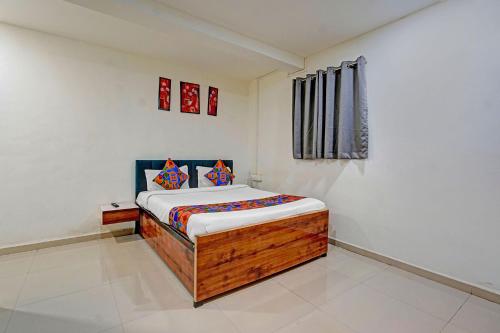 a small bedroom with a bed in a room at FabHotel Pearl Inn in Pune