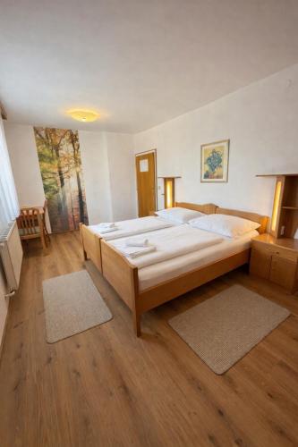 a large bedroom with a large bed in it at Leo's Pension in Bad Schallerbach