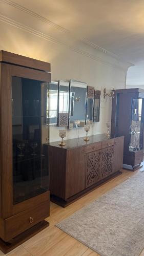 a large room with a large wooden cabinet with mirrors at Apartment on the Nile, 3 bedrooms and a living room in Cairo