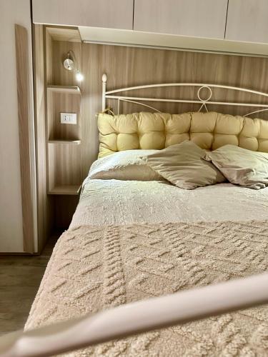 a bedroom with a large bed with a large headboard at L'Angolo Tranquillo in Monterosso al Mare