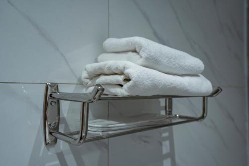 a stack of towels on a towel rack in a bathroom at Nozol Tabba in Medina