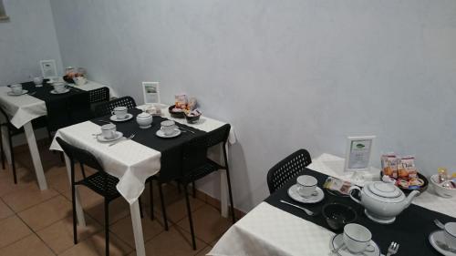 a room with tables and chairs with tea sets on them at B&B Verde Irpinia in Gesualdo