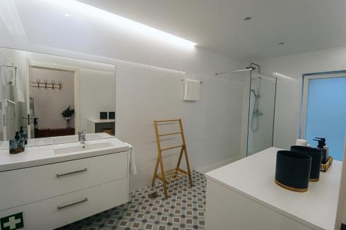 a bathroom with a sink and a mirror and a ladder at Peace In Azores 02 in Ribeira Grande