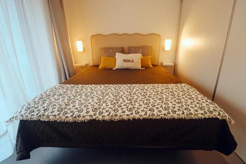 a bedroom with a large bed with yellow pillows at Peace In Azores 02 in Ribeira Grande