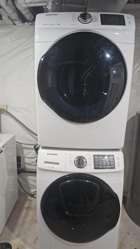 a white microwave oven sitting on top of a machine at 2 Bedroom Suite in Transcona in Winnipeg