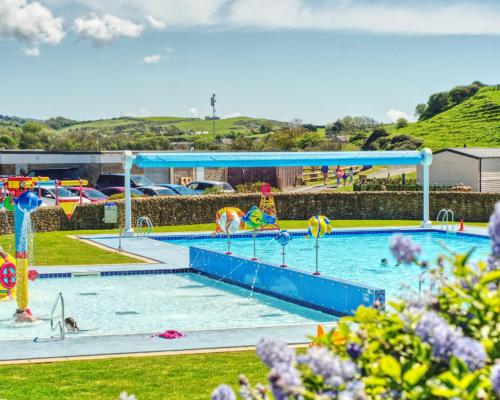 a large swimming pool with a water park at Driftwood at Freshwater Beach Holiday Park in Burton Bradstock