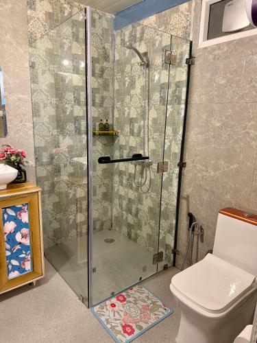 a shower stall in a bathroom with a toilet at The Mystic Loft in Dharamshala