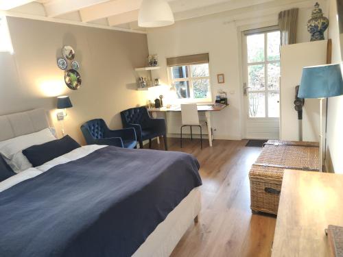 a bedroom with a bed and a table and chairs at B&B Hoofddorp in Hoofddorp